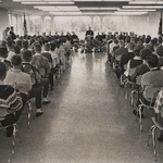 1960's people listening to speaker